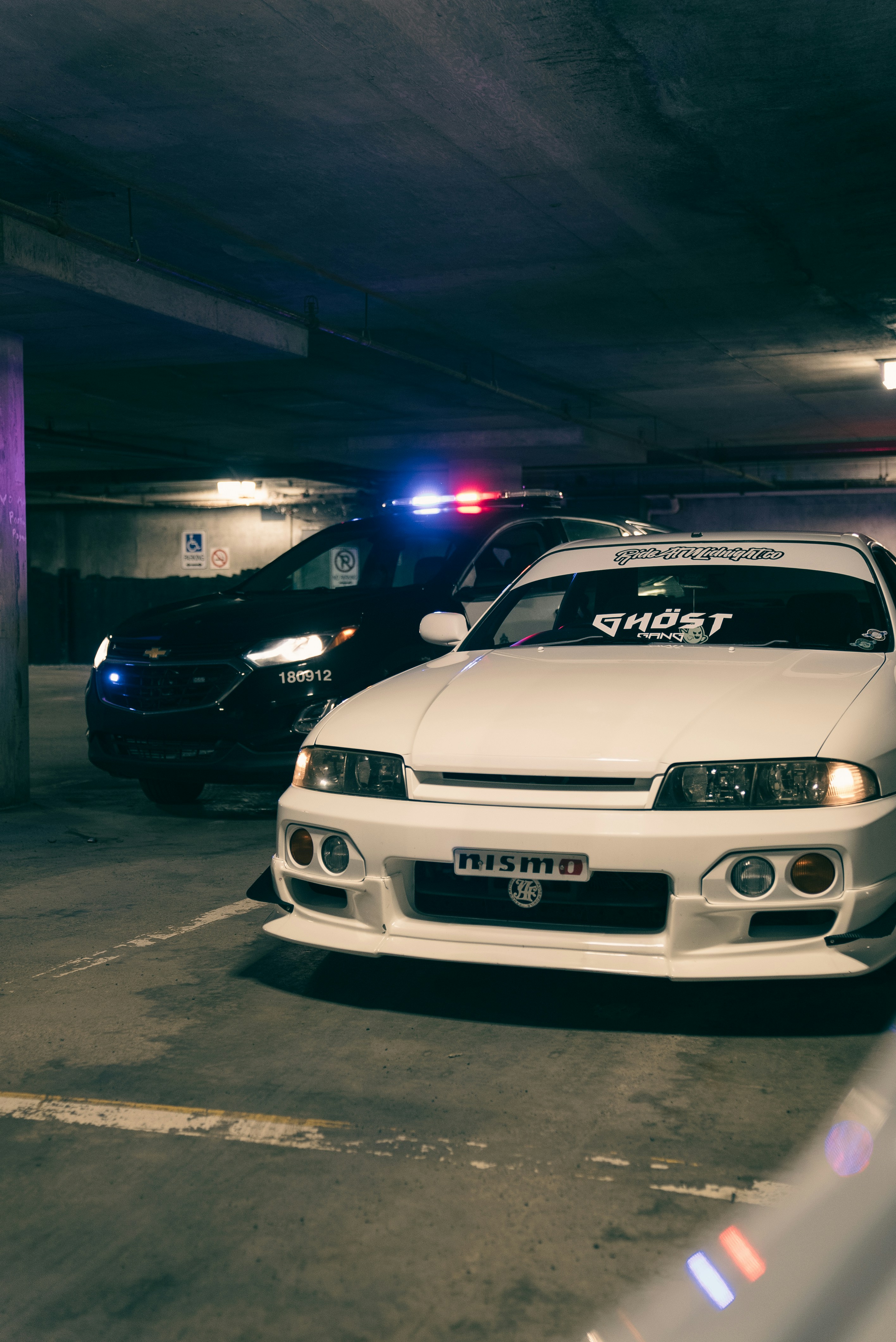 A white car parked in a parking garage